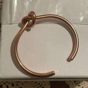 Brand new rose gold colored knot bracelet